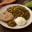 A plate of traditional Gujarati winter food featuring Undhiyu, Bajra Rotla, fresh green chutney, and creamy Makhan served on a rustic wooden table.