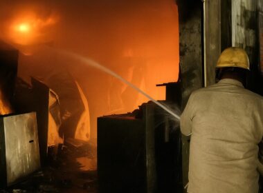 Firefighter dousing flames during the fire accident at Sanket India warehouse in Anand, Gujarat.